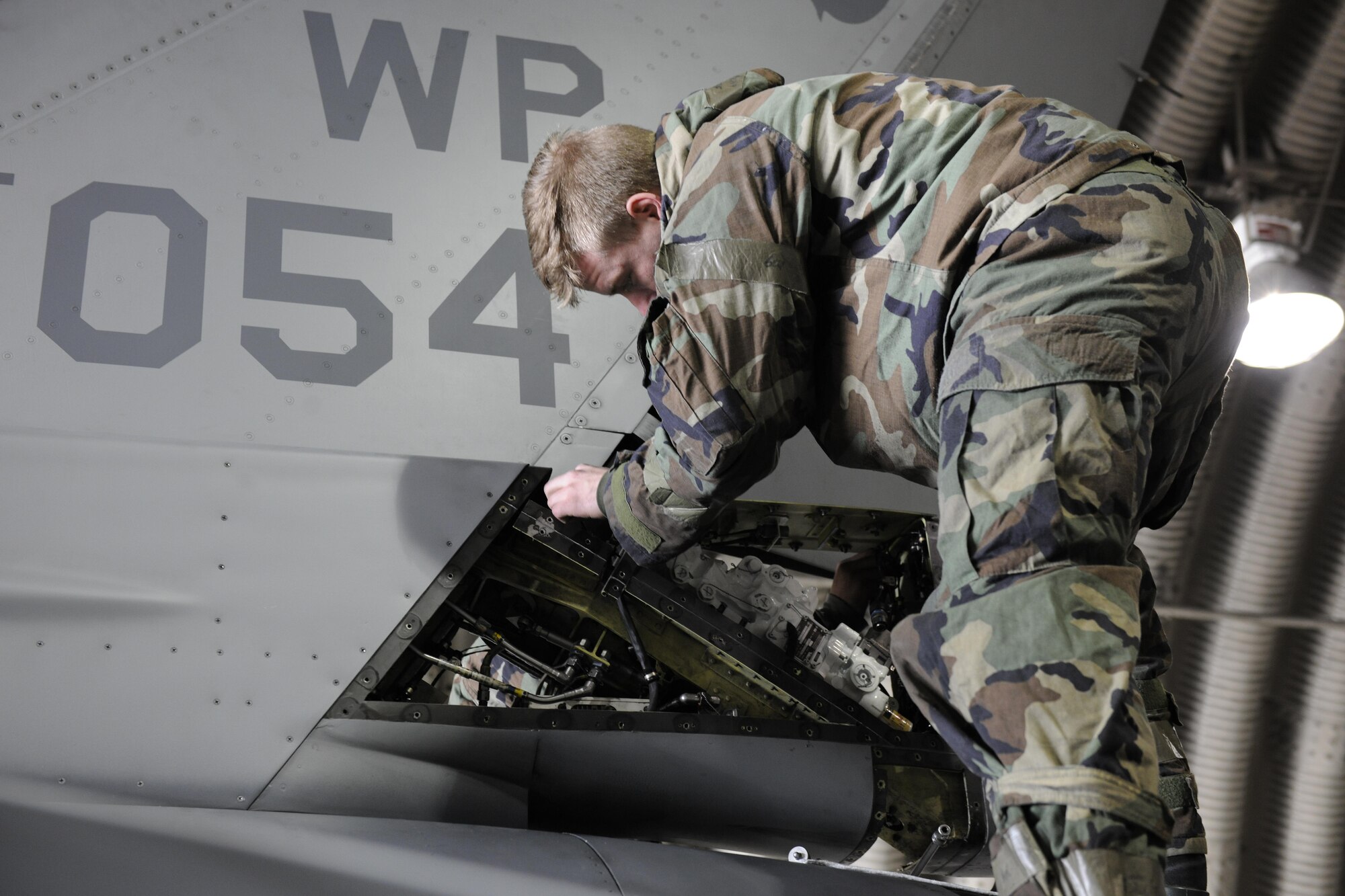 Staff Sgt. Brandon Rauchy, 80th Aircraft Maintenance Squadron dedicated crew chief, works on removing a rudder servo actuator on an F-16 Fighting Falcon during Beverly Pack 16-2 at Kunsan Air Base, Republic of Korea, Feb. 3, 2015. Airmen work around the clock no matter the condition during the exercises here on Kunsan. (U.S. Air Force photo by Senior Airman Dustin King/Released)