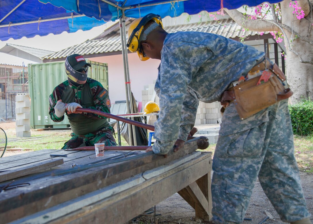 Indonesian Air Force Chief Private Imam Sugiri, with the Engineering Brigade, IAF, cutes rebar as U.S. Army Private 2nd Class James Garcia, with 797th Engineer Company, Vertical, U.S. Army Reserve Center Barrigada, Guam, holds the rebar during the Ban Phromnimit construction project Feb. 2, at Sakeao, Thailand. The construction at Ban Phromnimit is one of six HCA sites in which the Thai, U.S. and partner nation’s militaries will work together on civic programs during Cobra Gold 2016. Cobra Gold, in its 35th iteration, demonstrates the commitment of the Kingdom of Thailand and the U.S. to our long-standing alliance and regional partnership toward advancing prosperity and security in the Asia-Pacific region.