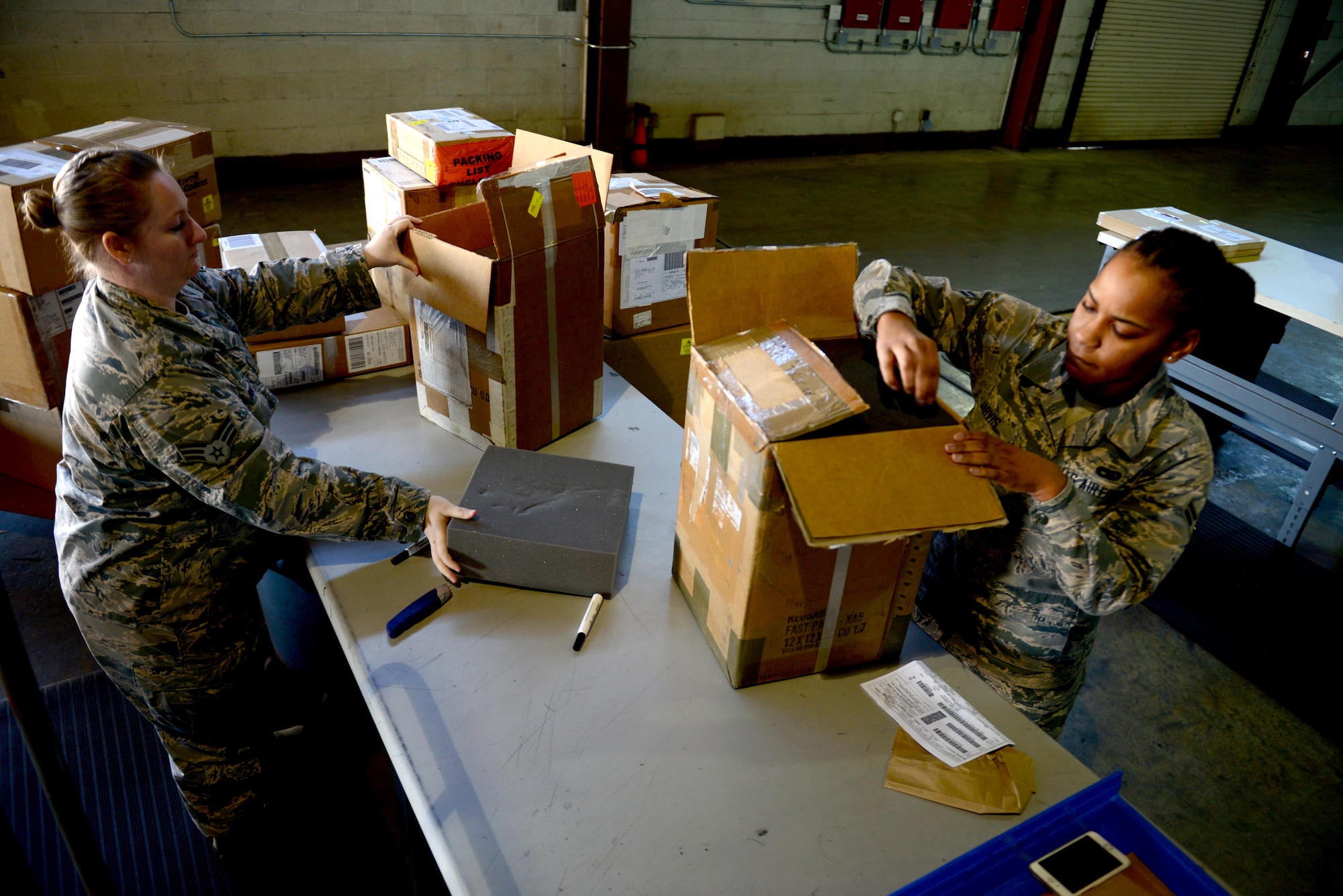 Senior Airman Megan Bright and Airman 1st Class Destiny Jarvis, 2nd Logistics Readiness Squadron traffic management Airmen, processed B-52 Stratofortress parts at Barksdale Air Force Base, La., Jan. 29, 2016. Traffic management Airmen process and move parts that are vital to repairing Aircraft, vehicles and anything used on a flightline. (U.S. Air Force photo/Airman 1st Class Luke Hill)