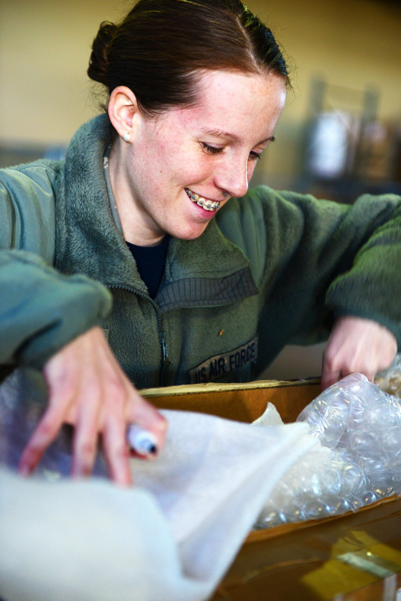 Senior Airman Joanna Barnette, 2nd Logistics Readiness Squadron traffic management journeyman, inspects a package at Barksdale Air Force Base, La., Jan. 29, 2016. Packages were inspected to ensure there were no broken or missing parts. (U.S. Air Force photo/Airman 1st Class Luke Hill)