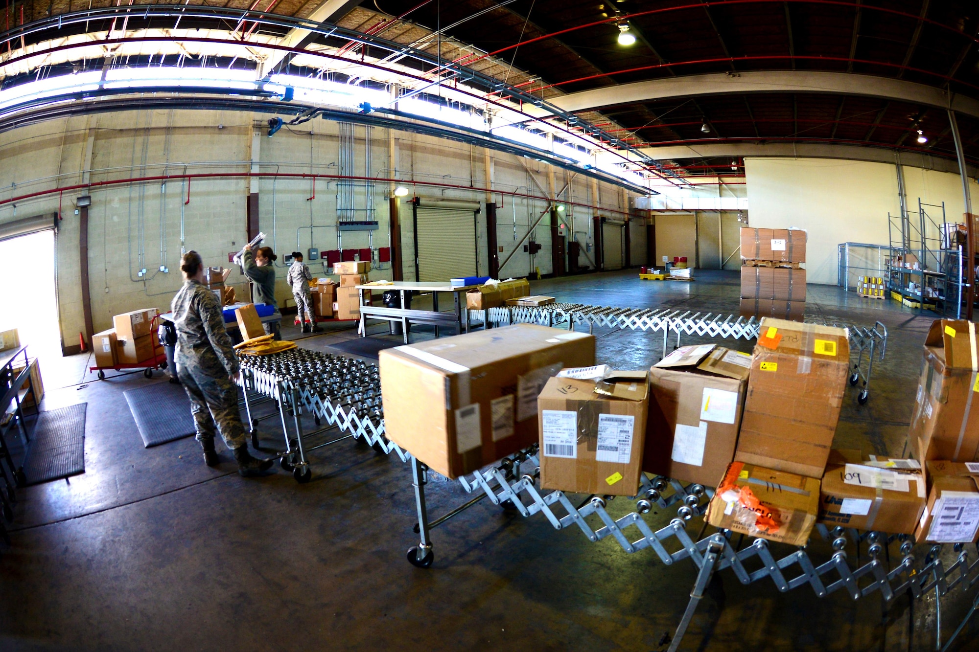 Airmen at 2nd Logistics Readiness Squadron traffic management receive and process packages at Barksdale Air Force Base, La., Jan. 29, 2016. Traffic management flight Airmen can process and ship out up to 300 packages a day. (U.S. Air Force photo/Airman 1st Class Luke Hill)

