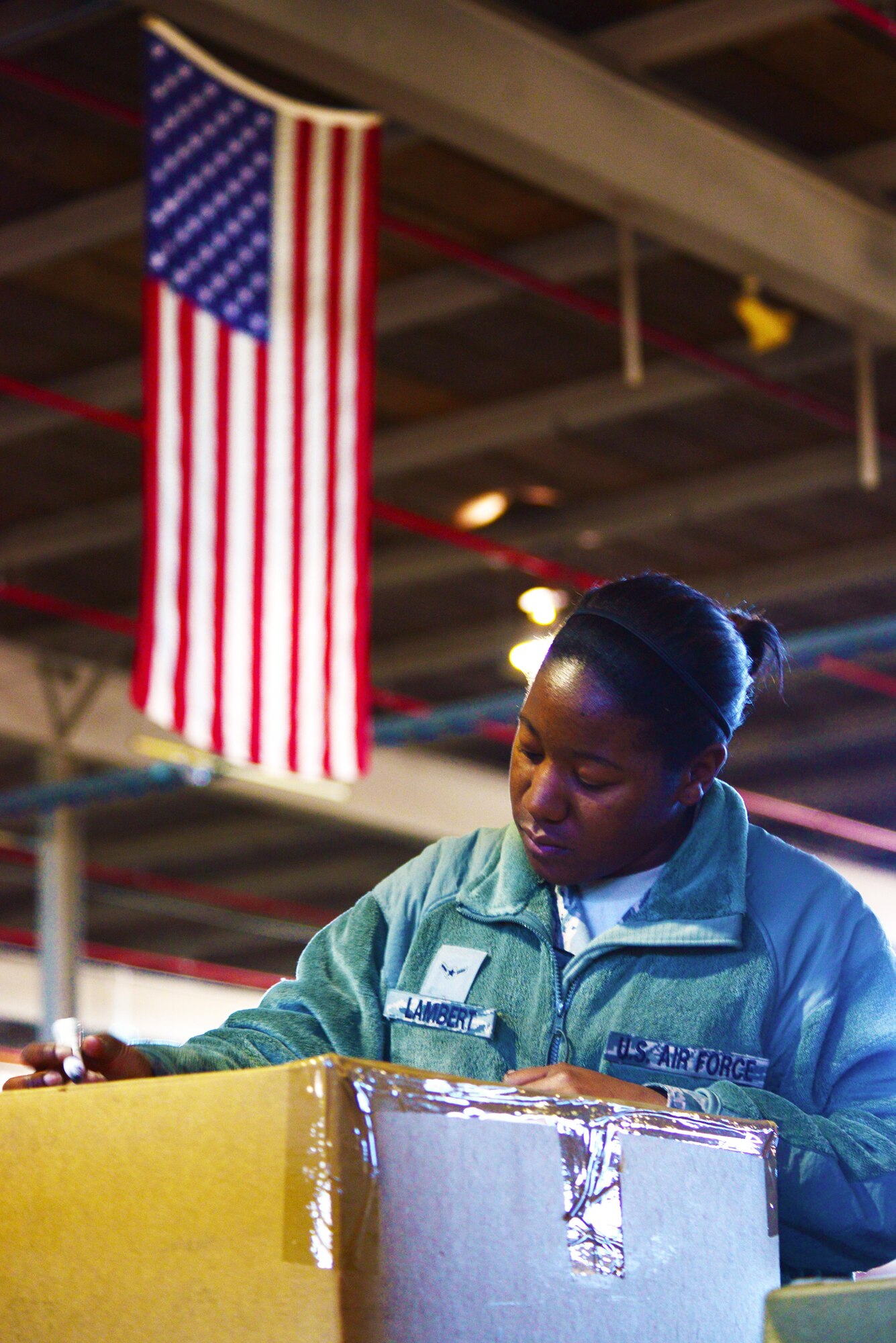 Airman Tayona Lambert, 2nd Logistics Readiness Squadron traffic management apprentice, tapes and marks a package so it can be weighed at Barksdale Air Force Base, La., Jan. 29, 2016. Traffic management flight Airmen have a 24-hour deadline to process and send packages. (U.S. Air Force photo/Airman 1st Class Luke Hill)
