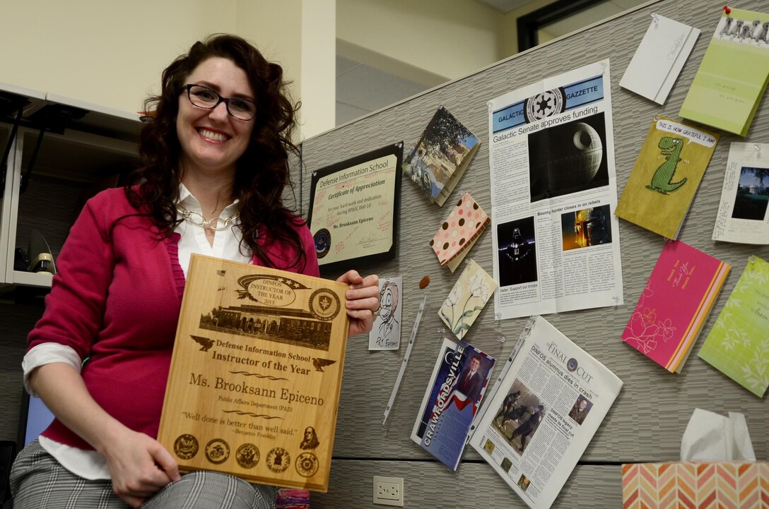 Brooksann Epiceno, an instructor at the Defense Information School on Fort Meade, poses with her Instructor of the Year award. Epiceno, a Coast Guard veteran, has been teaching at DINFOS since 2007.