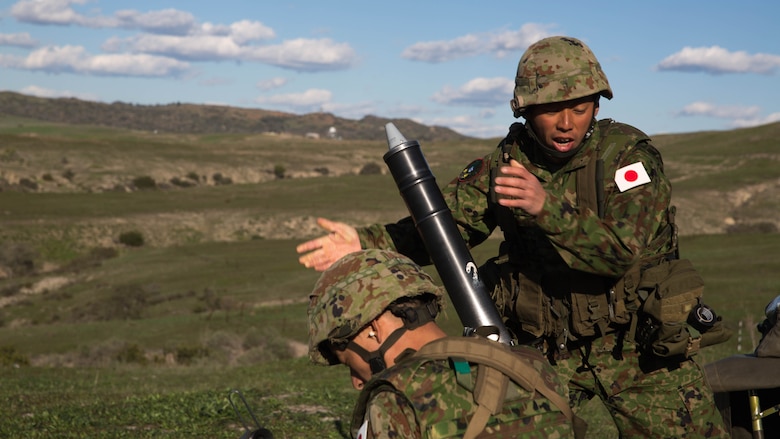 A Japan Ground Self-Defense Force mortarman drops a round down the tube of an 81mm mortar, during a live-fire training exercise, aboard Marine Corps Base Camp Pendleton, Calif., Feb 1, 2016. This mortar range is a part of the second phase of training the soldiers of the JGSDF and USMC will be conducting as a part of Exercise Iron Fist, which focuses on small unit skills and tactics before moving on to larger scale operations. 