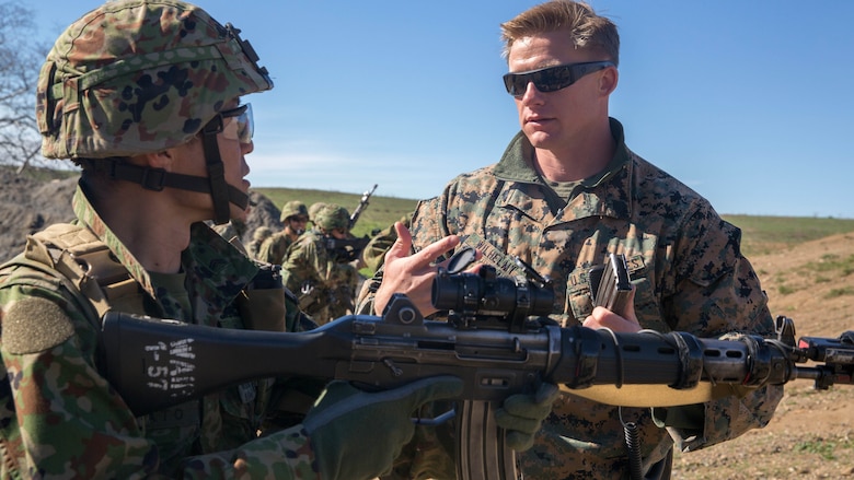United States Marine Corps Sgt. Mason Wilhelmy, a scout sniper instructor with 1st Marine Division Schools, discusses the Japan Ground Self-Defense Force’s Western Army Infantry Regiment’s Scout Sniper program with Sgt. First Class Kusumato at Marine Corps Base Camp Pendleton, Calif., Feb. 1, 2016. The two talked about different techniques and methods used to conduct tactical and speed ammunition reloads during an abbreviated scout sniper course at Exercise Iron Fist 2016.The abbreviated scout sniper course gave the U.S. Marines and JGSDF soldiers the opportunity to share their experiences and knowledge and increase camaraderie between the Marine Corps and JGSDF. 