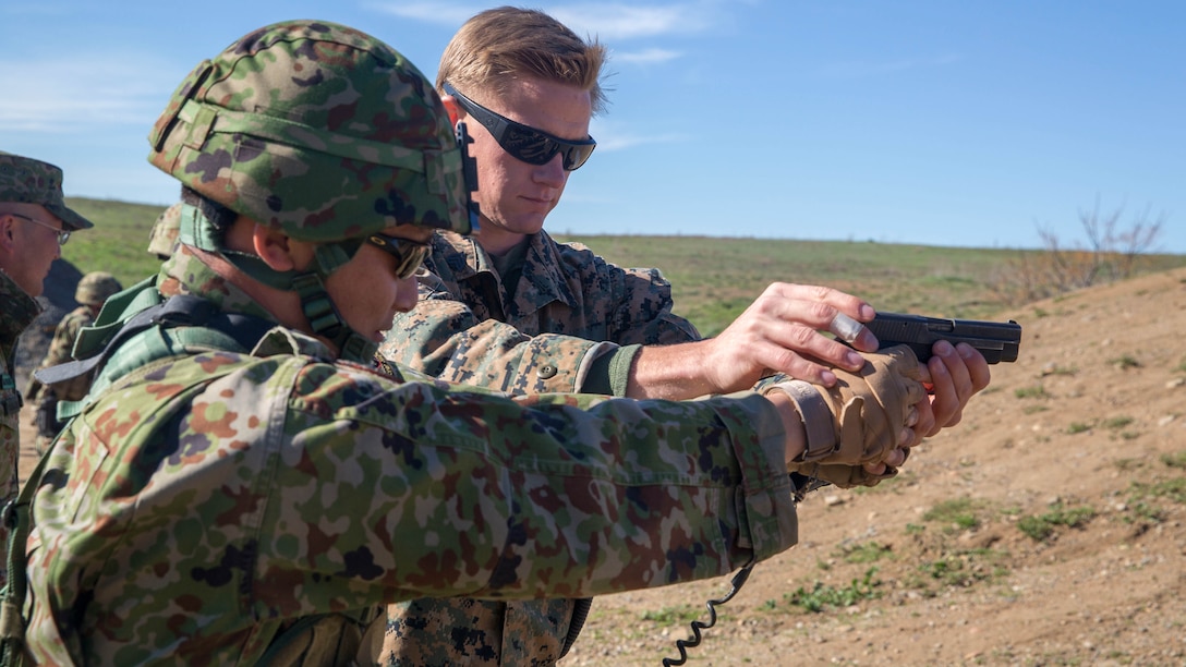 United States Marine Corps Sgt. Mason Wilhelmy, scout sniper instructor, 1st Marine Division Schools, assists a soldier of the Japan Ground Self-Defense Force’s Western Army Infantry Regiment’s Scout Sniper program with proper pistol grip during an abbreviated scout sniper course, instructed by Marine Corps scout sniper instructors, during Exercise Iron Fist 2016 on Marine Corps Base Camp Pendleton, Calif., Feb. 1, 2016. Iron Fist is an annual, bilateral amphibious training exercise designed to improve the Marine Corps and JGSDF’s ability to plan, communicate and conduct combined amphibious operations. Operating in small teams, scout snipers can be used to conduct reconnaissance and eliminate targets prior to an amphibious assault.