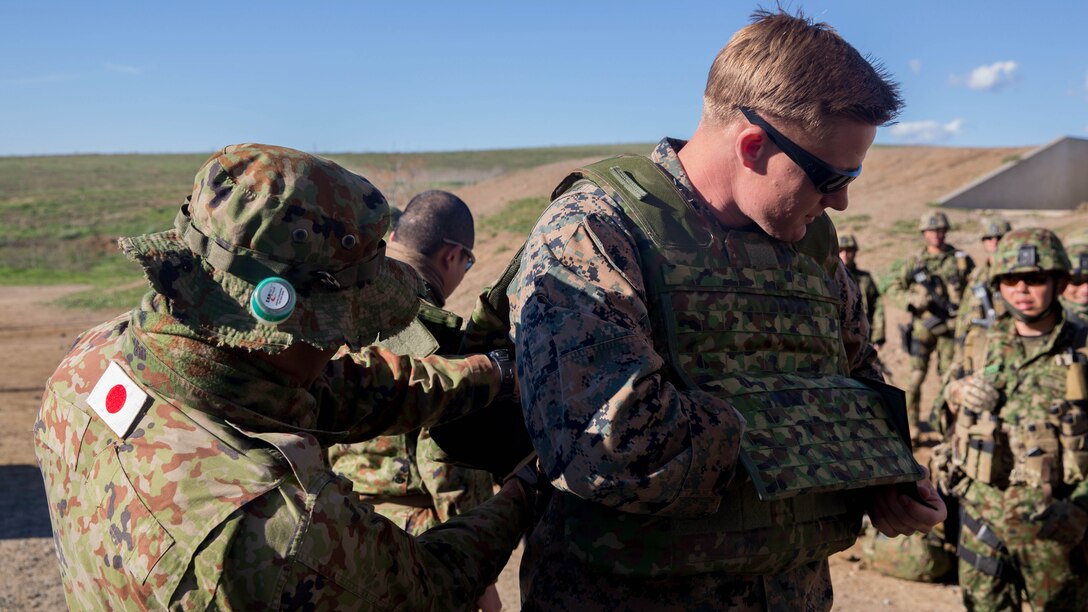 United States Marine Corps Sgt. Mason Wilhelmy, a scout sniper instructor with 1st Marine Division Schools, tries on a Japan Ground Self-Defense Force, Western Army Infantry Regiment soldier’s flak jacket during a scout sniper course at Exercise Iron Fist 2016 on Marine Corps Base Camp Pendleton, Calif., Feb. 1, 2016. Iron Fist affords the Marines and JGSDF soldiers the opportunity to share their experience and knowledge while increasing camaraderie between the U.S. Marine Corps and JGSDF. 