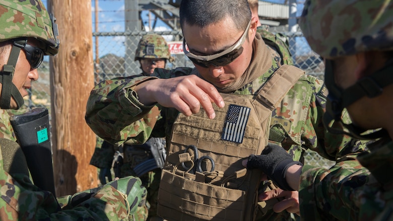 Soldiers of the Japan Ground Self-Defense Force’s Western Army Infantry Regiment Scout Sniper program assist a fellow soldier as he tries on a U.S. Marine Corps flak jacket during an abbreviated scout sniper course, instructed by Marine Corps Scout Sniper instructors, during Exercise Iron Fist 2016 on Marine Corps Base Camp Pendleton, Calif., Feb. 1, 2016. Iron Fist affords U.S. Marines and JGSDF soldiers the opportunity to share their experiences and knowledge as they train alongside each other. 