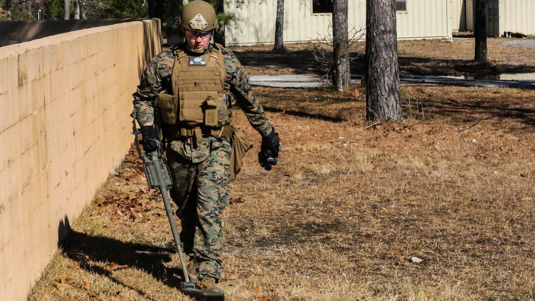 Staff Sgt. Chaz Carter, an Explosive Ordnance Disposal technician with EOD Company, 8th Engineer Support Battalion, searches the area during an improvised explosive device access training exercise aboard Camp Lejeune, N.C., Jan. 29, 2016. During the exercise, evaluators assessed Marines on safely locating and disposing of an IED while suppressing the full capabilities of the threat. 