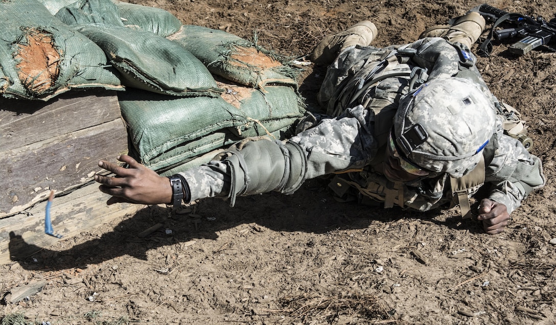 A Soldier in Basic Combat Training with C Company, 1st Battalion, 61st Infantry Regiment tosses a practice grenade into a bunker on the hand grenade assault course at Fort Jackson, S.C., Feb. 1, 2016. (U.S. Army photo by Sgt. 1st Class Brian Hamilton)