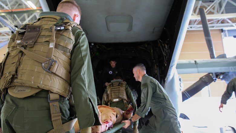 Petty Officer 2nd Class Mark Skaggs teaches Lance Cpl. Michael Jacobsen how to properly load casualties onto aircraft during a simulated casualty evacuation scenario at Marine Corps Base Camp Pendleton, Jan. 27, 2016. This training was part of the newly formed combat operation medical emergency transport training. COMETT exposes the aircrew to medical emergencies and procedures they may encounter in combat and non-combat environments. Jacobsen is an ordnance technician with Marine Aircraft Group 29. 