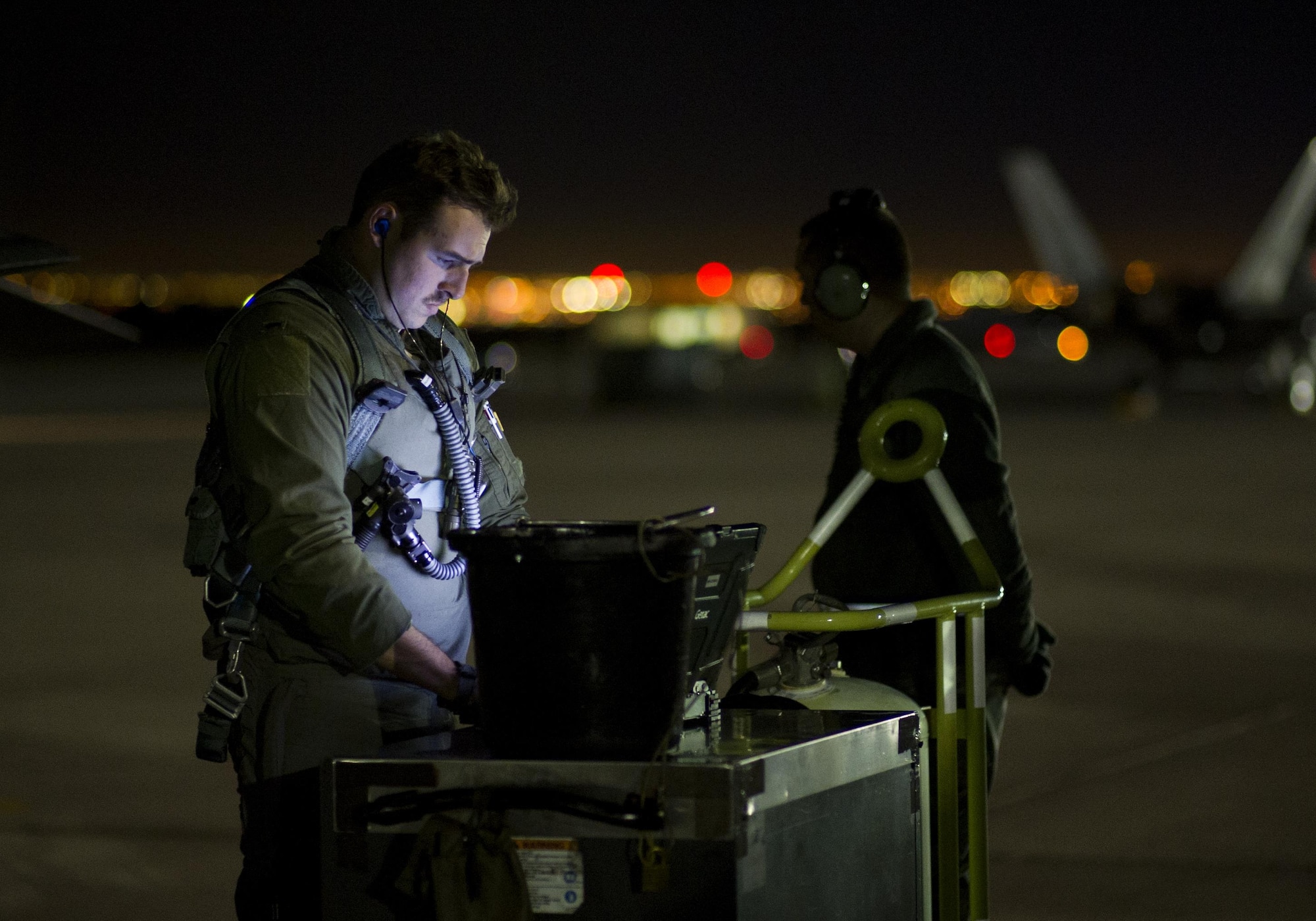 First Lt. Douglas Foss, a 95th Fighter Squadron F-22 Raptor pilot, goes through preflight procedures during Red Flag 16-1, Jan. 26, 2016, at Nellis Air Force Base, Nev. More than 30 squadrons at Red Flag 16-1 worked together, some for the first time, training and preparing for a variety of possible threats. (U.S. Air Force photo/Senior Airman Alex Fox Echols III)