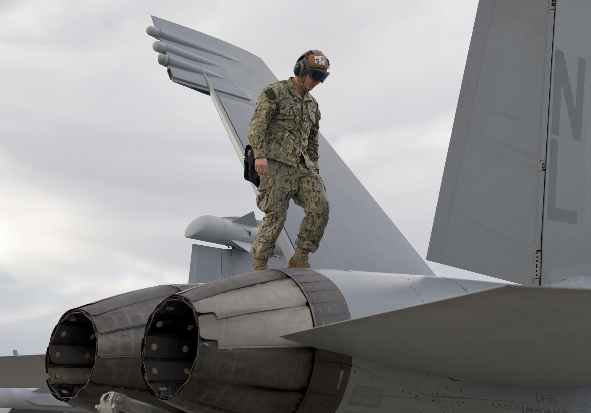 A U.S. Navy Airman Ryan Smith, a VAQ-138 plane captain stationed at Naval Air Station Whidbey Island, Wash., marshals in an EA-18G Growler during Red Flag 16-1, Jan. 29, 2016, at Nellis Air Force Base, Nev. The Airmen were part of more than 3,000 personnel from over 30 units, including squadrons from Australia and the U.K., to participate in Red Flag 16-1. (U.S. Air Force photo/Senior Airman Alex Fox Echols III)