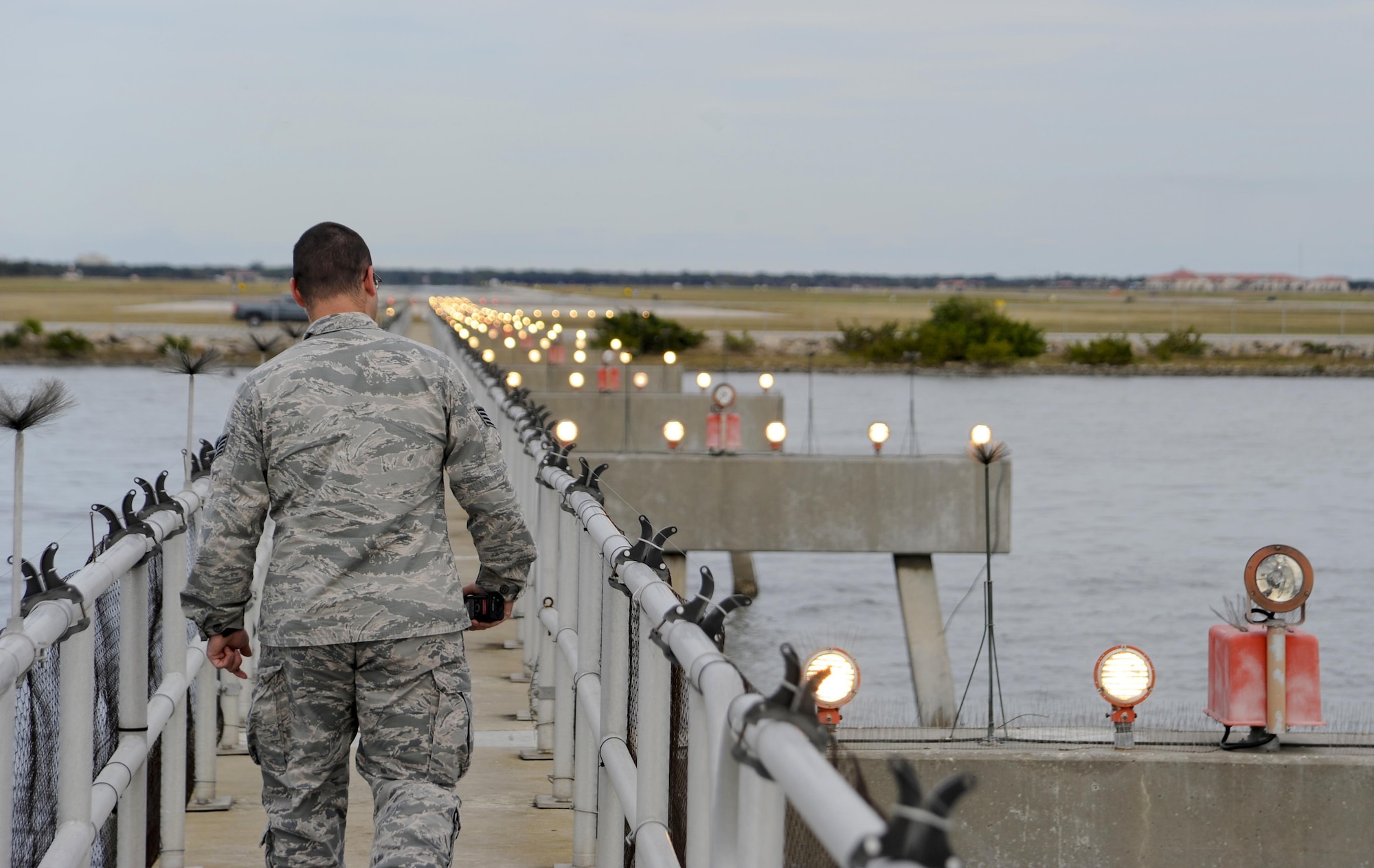 Staff Sgt. Michael David, an airfield management operations supervisor with the 6th Operations Support Squadron, inspects the sequenced flashing lights used for aircraft landing at MacDill Air Force Base, Fla., Jan. 22, 2016. Airfield management Airmen are responsible for performing multiple daily airfield checks to ensure the it is safe for aircraft. (U.S. Air Force photo/Airman 1st Class Mariette M. Adams)