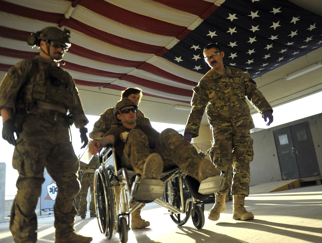 Air Force Maj. (Dr.) Kenneth Beadle, right, assists a simulated patient into the emergency room during an extrication exercise at Bagram Airfield, Afghanistan Jan. 23, 2016. Beadle is an emergency room physician assigned to Craig Joint Theater Hospital, deployed from Eglin Air Force Base, Fla. Air Force photo by Capt. Bryan Bouchard