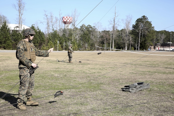 Sgt. Gordon Rodgers, a field radio operator with Headquarters Company, Combat Logistics Regiment 25, raises an antenna during a command post exercise at Camp Lejeune, N.C., Feb. 2, 2016. The mission of 2nd Marine Logistics Group is to provide general support combat logistics to all forces operating in the II Marine Expeditionary Force battlespace. (U.S. Marine Corps photo by Cpl. Paul S. Martinez/Released)
