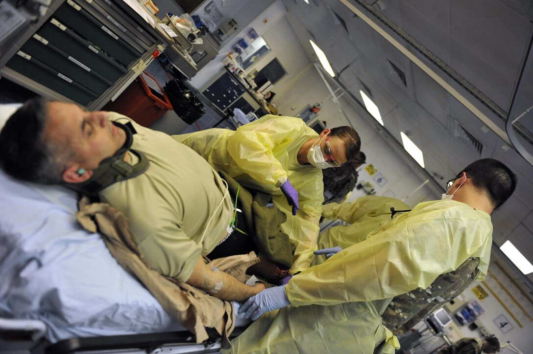 Service members treat Air Force Brig. Gen. Dave Julazadeh, left, 455th Air Expeditionary Wing commander, as he role plays a casualty during an extrication exercise at Craig Joint Theater Hospital on Bagram Airfield, Afghanistan Jan. 23, 2016. Air Force photo by Capt. Bryan Bouchard 