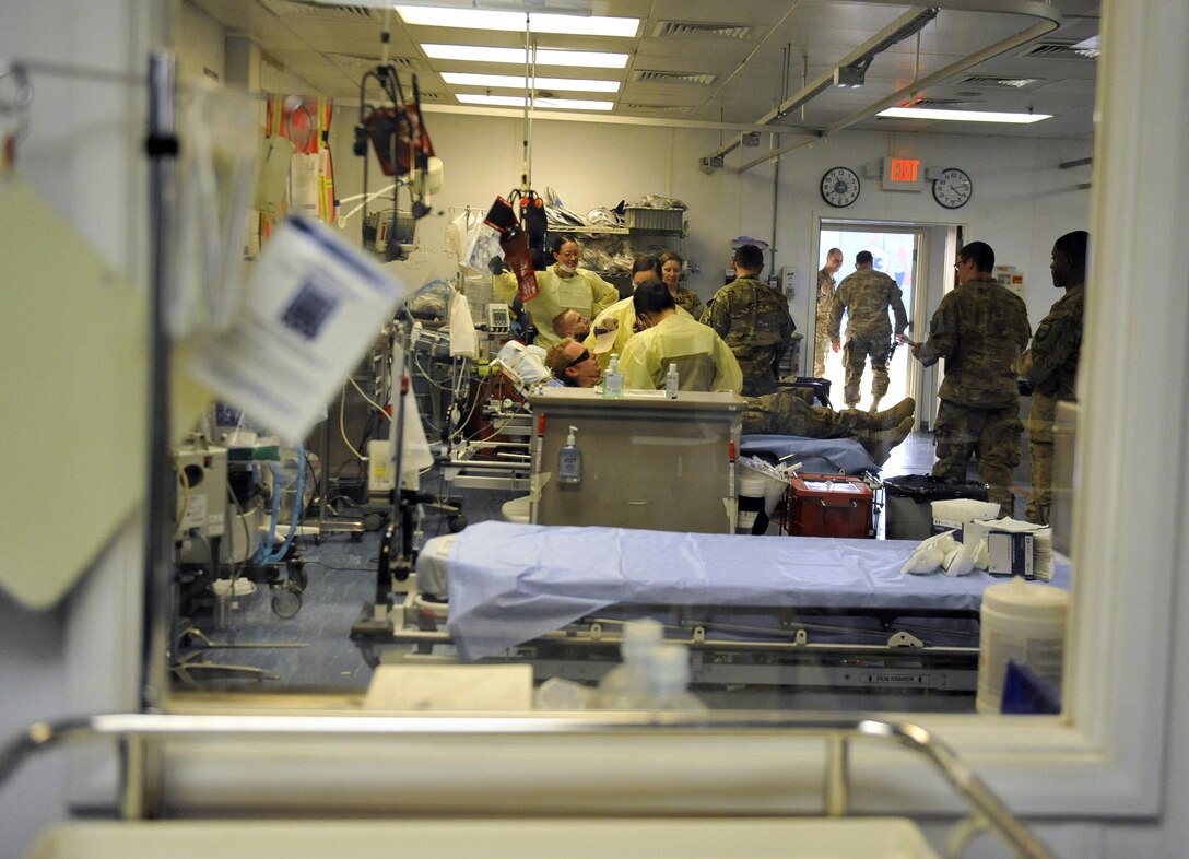 Service members provide medical treatment to simulated patients during an extrication exercise in the Craig Joint Theater Hospital on Bagram Airfield, Afghanistan, Jan. 23, 2016. Air Force photo by Capt. Bryan Bouchard