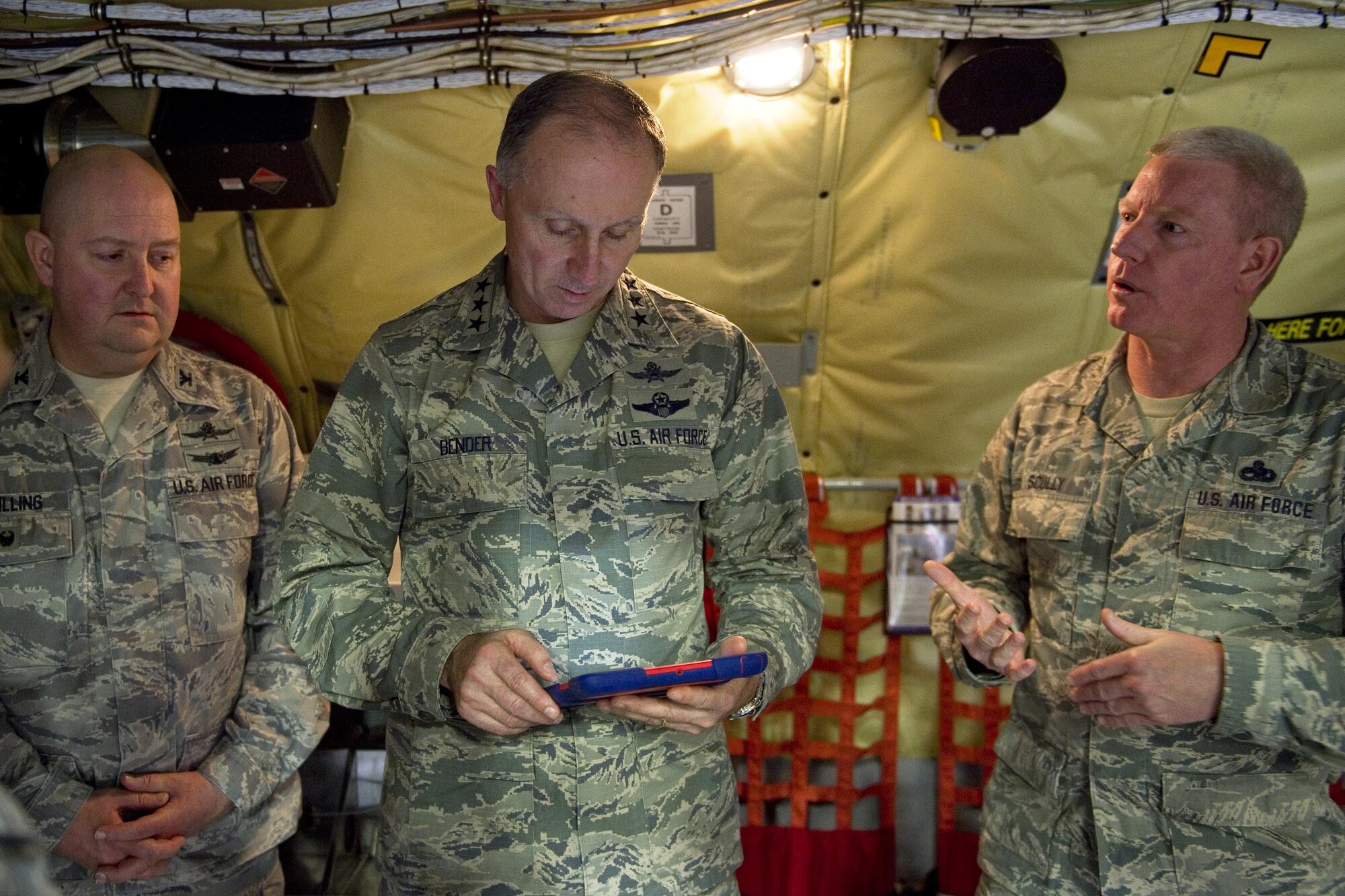 Lt. Gen. Bill Bender, Air Force chief of information dominance and chief information officer, uses an electronic notepad to display technical orders as Chief Master Sgt. Richard Scully, 434th Maintenance Group chief of quality assurance, explains their capabilities during his visit to Grissom Air Reserve Base, Ind., Jan. 14, 2016. The 434th ARW was recently selected as one of two lead pilot squadrons in the Air Force Reserve Command to transition into a next generation communications squadron. (U.S. Air Force photo/Tech. Sgt. Benjamin Mota)