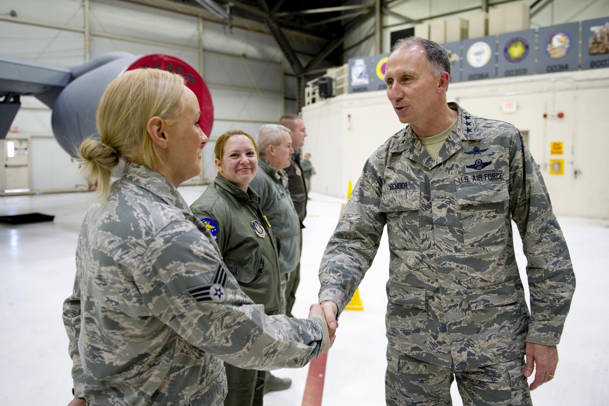 Lt. Gen. Bill Bender, Air Force chief of information dominance and chief information officer, shakes hands with Senior Airman Caroline Taylor, 434th Aircraft Maintenance crew chief, and other KC-135 Stratotanker aircrew during a visit to Grissom Air Reserve Base, Ind., Jan. 14, 2016. During the visit, Bender had an opportunity to speak with Airmen about cyber security concerns and explain how Grissom was leading the way through a new cyber security pilot program. (U.S. Air Force photo/Tech. Sgt. Benjamin Mota)