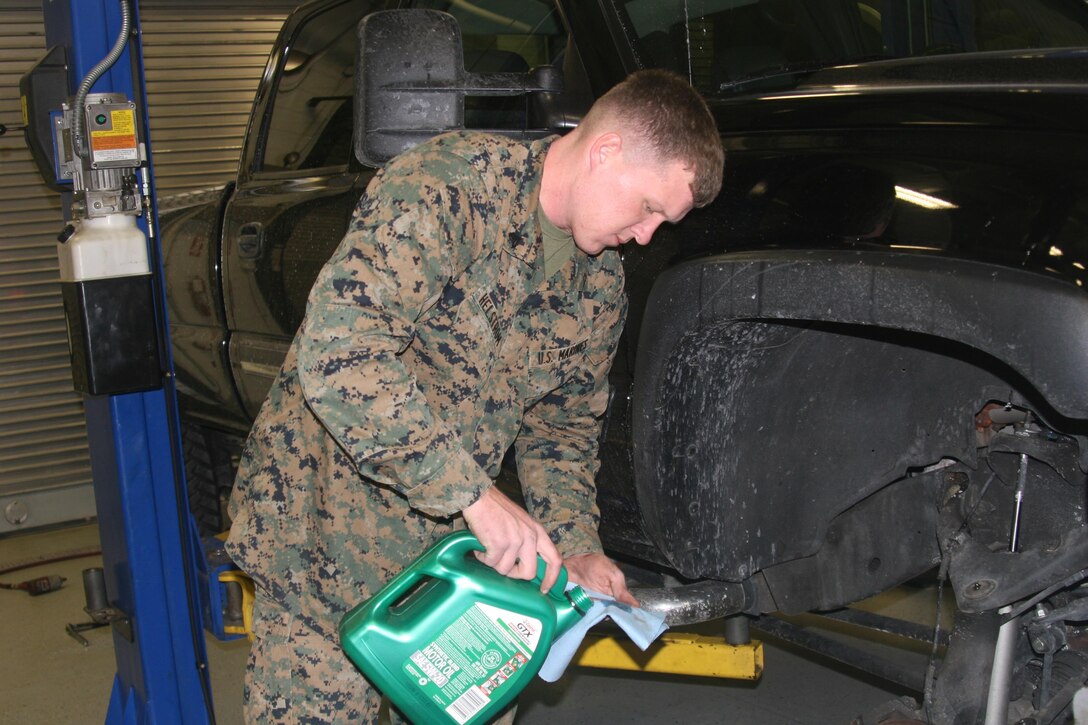 Cpl. Bret Helstrom, Motor Transport Operations, lubes the wheel bearings on his truck at the Auto Skills Center aboard Marine Corps Base Quantico Jan. 21.