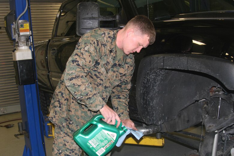 Cpl. Bret Helstrom, Motor Transport Operations, lubes the wheel bearings on his truck at the Auto Skills Center aboard Marine Corps Base Quantico Jan. 21.