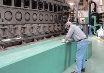 An engineer gathers diesel engine nameplate data for energy audit at Graham Burke Pumping Station, Arkansas.