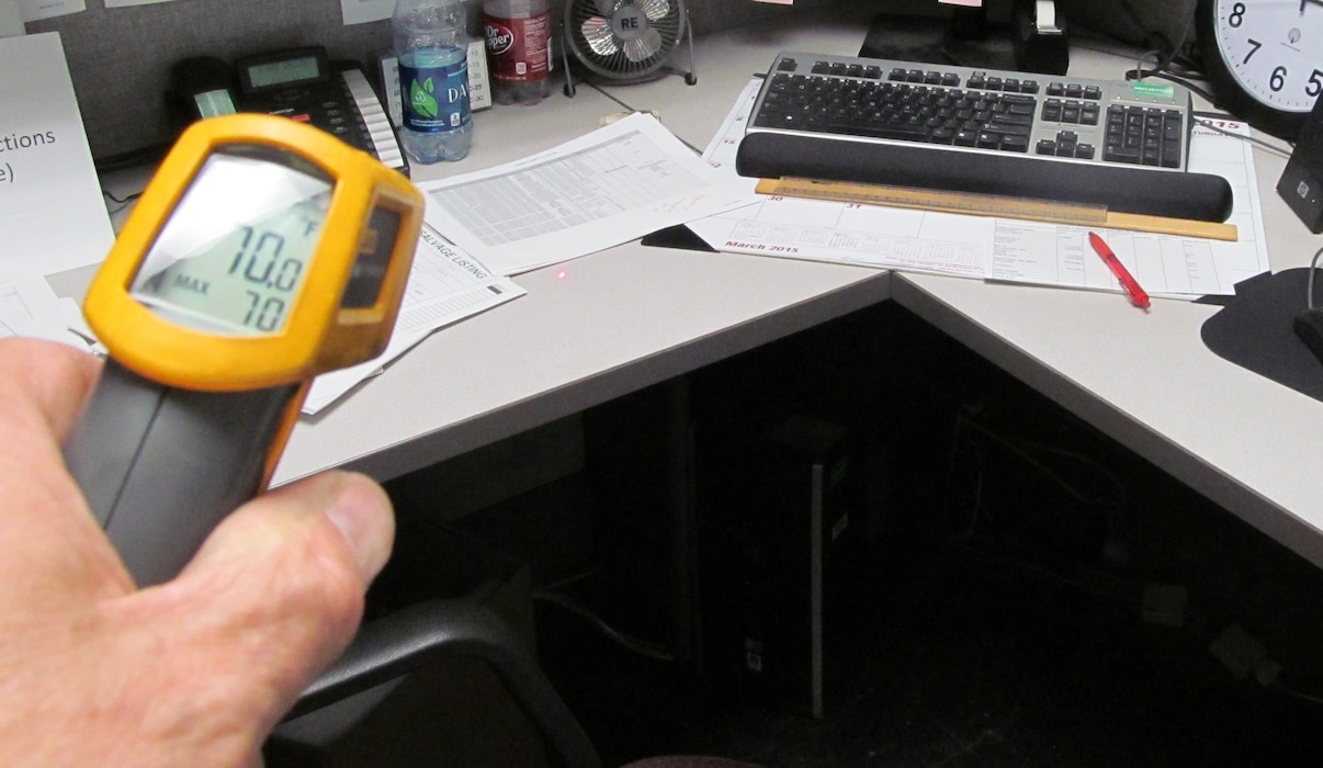 AN EEAP engineer conducts a room temperature measurement in an office space for a Level I energy audit at Red River Army Depot. A Level I audit satisfies one of the pre-requisite requirements for the U.S. Green Building Council’s Leadership in Energy & Environmental Design (LEED) for Existing Buildings: Operations and Maintenance. 
