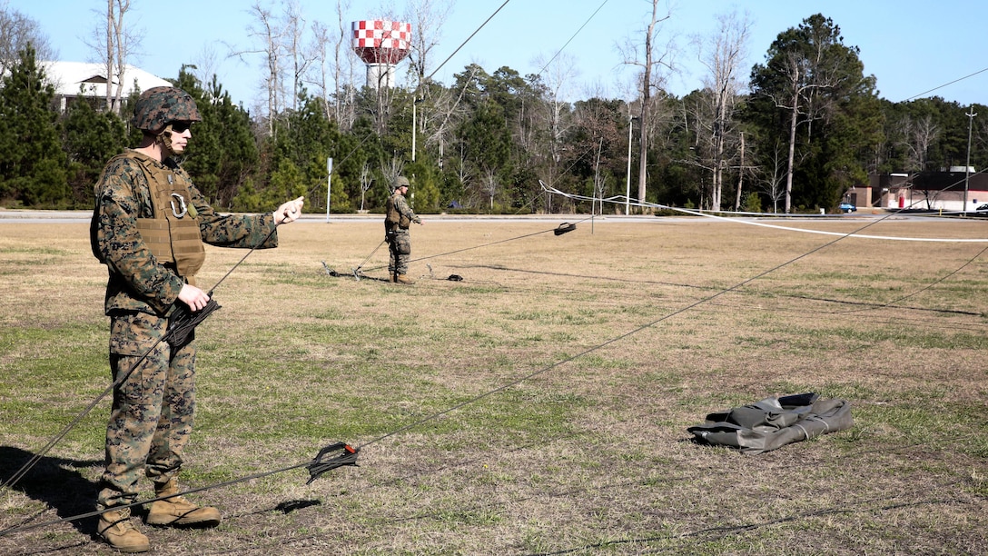 Sgt. Gordon Rodgers, a field radio operator with Headquarters Company, Combat Logistics Regiment 25, raises an antenna during a command post exercise at Camp Lejeune, N.C., Feb. 2, 2016. The mission of 2nd Marine Logistics Group is to provide general support combat logistics to all forces operating in the II Marine Expeditionary Force battlespace. 