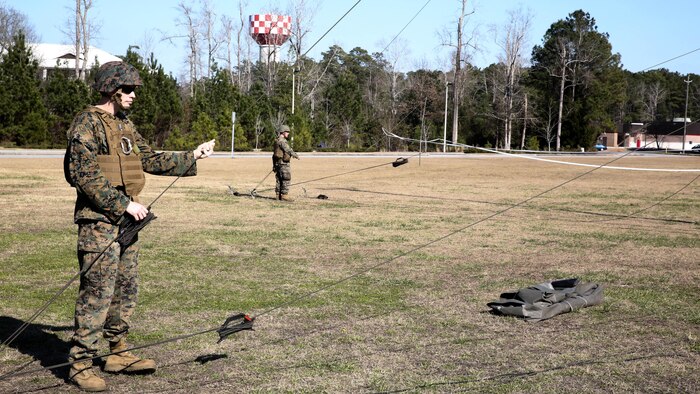 Sgt. Gordon Rodgers, a field radio operator with Headquarters Company, Combat Logistics Regiment 25, raises an antenna during a command post exercise at Camp Lejeune, N.C., Feb. 2, 2016. The mission of 2nd Marine Logistics Group is to provide general support combat logistics to all forces operating in the II Marine Expeditionary Force battlespace. 