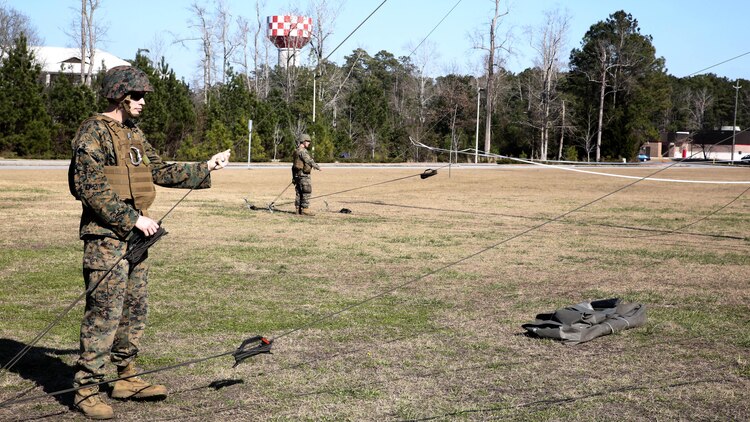 Sgt. Gordon Rodgers, a field radio operator with Headquarters Company, Combat Logistics Regiment 25, raises an antenna during a command post exercise at Camp Lejeune, N.C., Feb. 2, 2016. The mission of 2nd Marine Logistics Group is to provide general support combat logistics to all forces operating in the II Marine Expeditionary Force battlespace. 