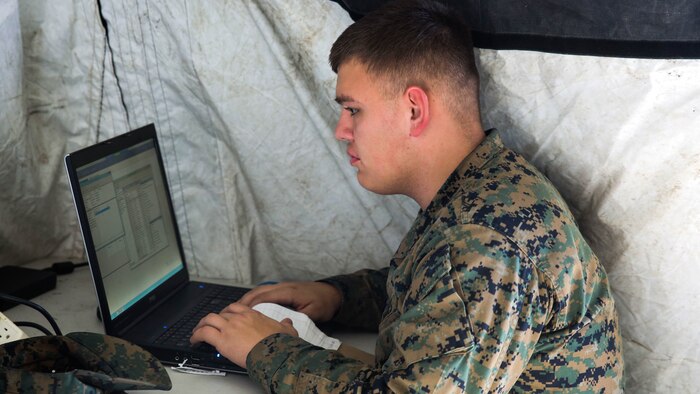 Pfc. Alec Rivera, a cyber-network specialist with Headquarters Company, Combat Logistics Regiment 25, works on a computer during a command post exercise at Camp Lejeune, N.C., Feb. 2, 2016. As a cyber-network specialist, Rivera is responsible for configuring and maintaining connectivity across networks. 