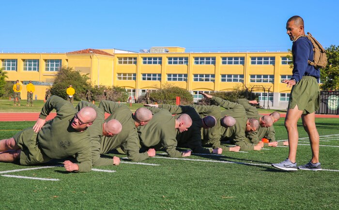 A drill instructor of Mike Company, 3rd Recruit Training Battalion, yells at a recruit for not following directions during the bases event at Marine Corps Recruit Depot San Diego, Feb. 2. Drill instructors watched the recruits to make sure they were doing the exercises correctly and motivated them if they started to slow down. Annually, more than 17,000 males recruited from the Western Recruiting Region are trained at MCRD San Diego. Mike Company is scheduled to graduate April 15.
