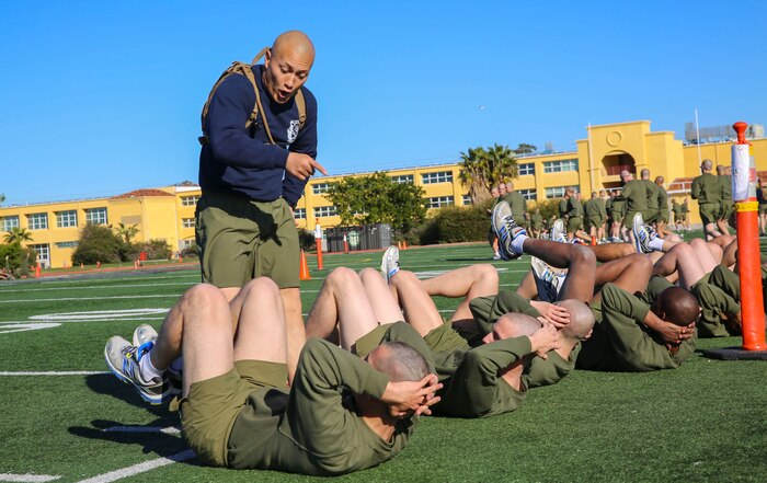 A drill instructor of Mike Company, 3rd Recruit Training Battalion, yells at a recruit for moving too slowly during the bases event at Marine Corps Recruit Depot San Diego, Feb. 2. Drill instructors watched the recruits to make sure they were doing the exercises correctly and motivated them if they started to slow down. Annually, more than 17,000 males recruited from the Western Recruiting Region are trained at MCRD San Diego. Mike Company is scheduled to graduate April 15.