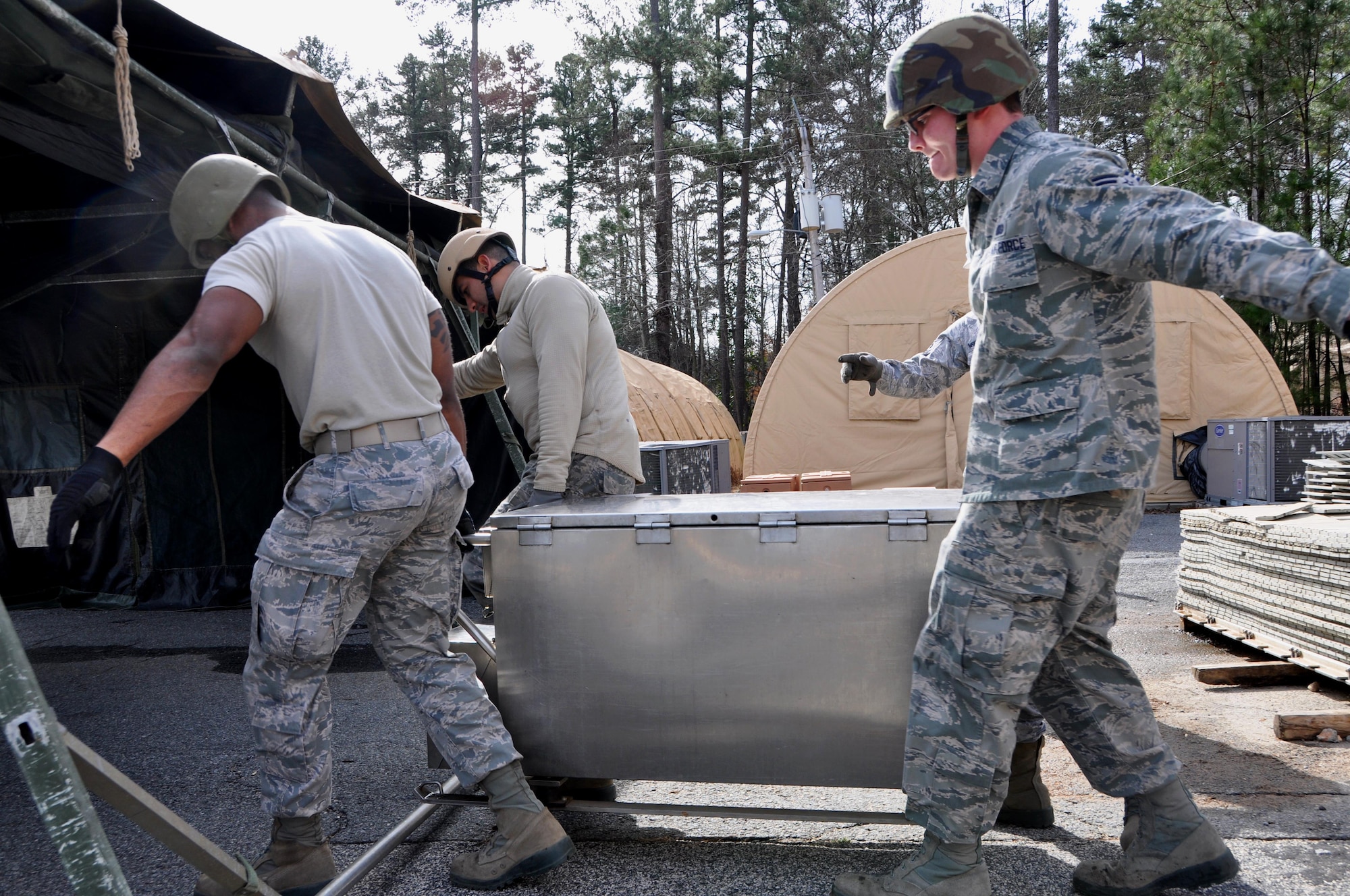 Force Support Silver Flag students at Dobbins Air Reserve Base work together to transport a field sanitation unit into the single palletized expeditionary kitchen Jan. 25, 2016 at Dobbins Air Reserve Base, Ga. The SPEK is where food is prepared and served. (Photo by U.S. Air Force Senior Airman Lauren Douglas) 