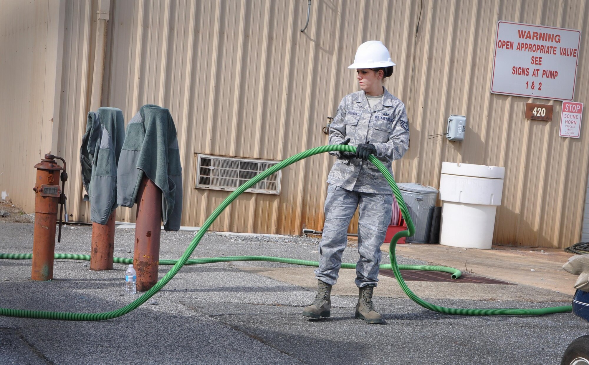 Training instructor Tech. Sgt. Emily Ferguson, 622nd Civil Engineer Group Force Support Silver Flag, assists in pulling the water source to the field sanitation unit Jan. 25, 2016 at Dobbins Air Reserve Base, Ga. The training provided practice in a field environment so students are prepared for deployment responsibilities before deploying. (Photo by U.S. Air Force Senior Airman Lauren Douglas)