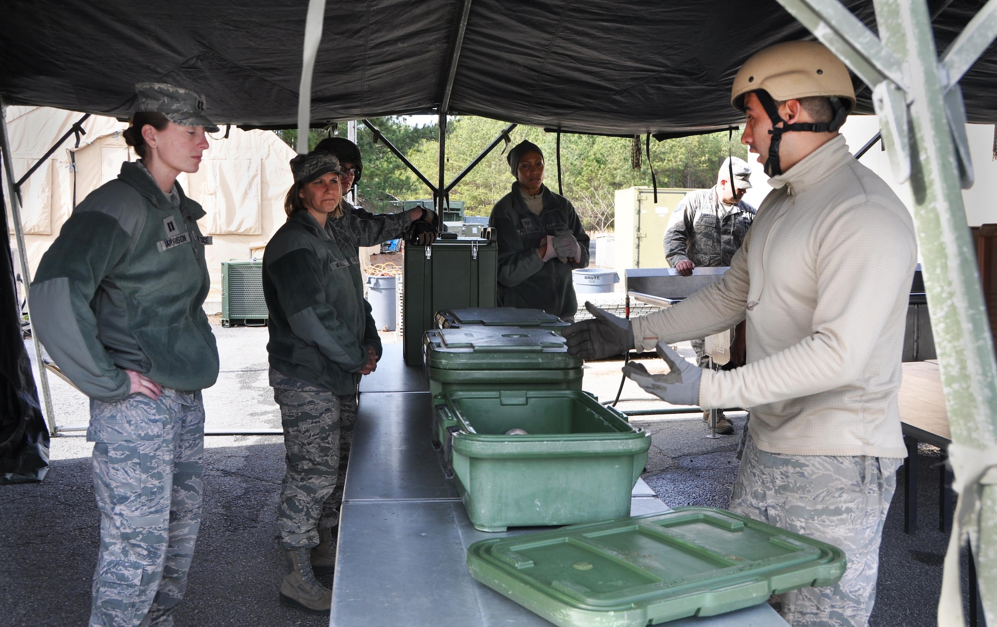 Staff Sgt. Carlos Morales, 366th Force Support Squadron food service shift leader, shows off his service knowledge for a captain and master sergeant who came to observe the training Jan. 25, 2016 at Dobbins Air Reserve Base, Ga. Morales was a Force support student. Throughout the training week, students spent time learning about the physical set up for lodging and food service tent structures. (Photo by U.S. Air Force Senior Airman Lauren Douglas)