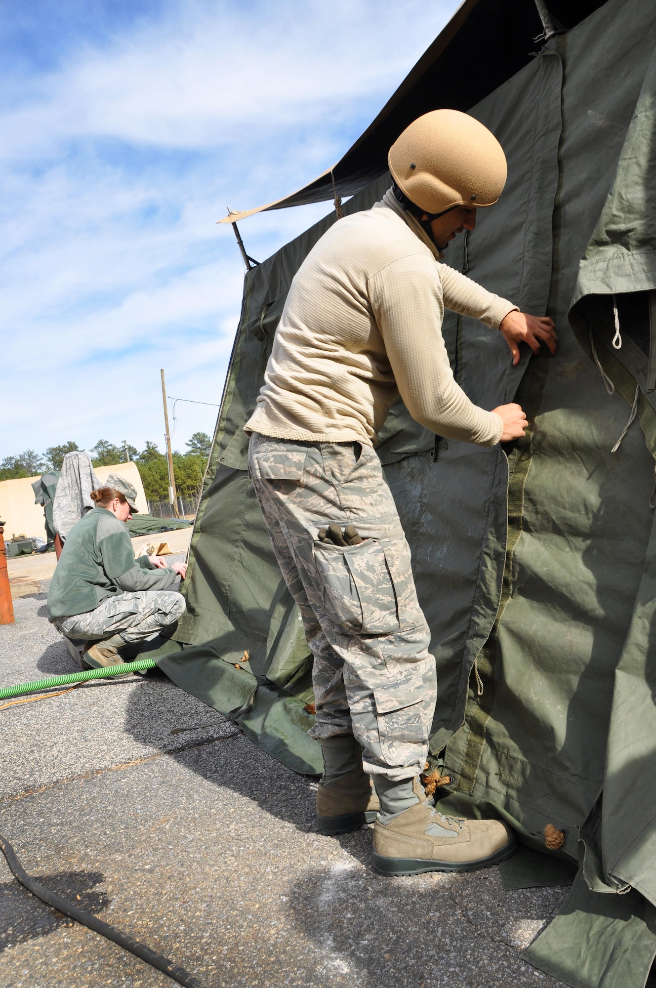 Staff Sgt. Carlos Morales, 366th Force Support Squadron food service shift leader, and Capt. Marti Garrison, combat capability evaluator, assist in securing a single palletized expeditionary kitchen Jan. 25, 2016 at Dobbins Air Reserve Base, Ga. Garrison came to observe the training process and decided to lend a helping hand. (Photo by U.S. Air Force Senior Airman Lauren Douglas)