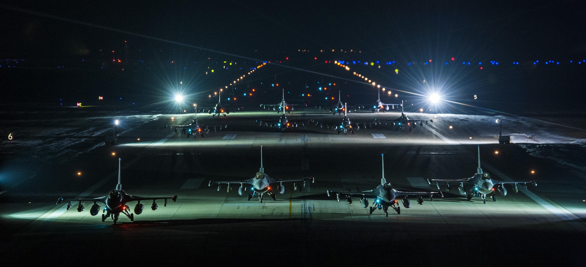 Twenty F-16s from the 8th Fighter Wing line up for an elephant walk early in the morning on Feb. 3, 2016 at Kunsan Air Base, Republic of Korea. The elephant walk was designed to test the 8 FW's ability to launch aircraft at a moment's notice. (U.S Air Force photo by Staff Sgt. Nick Wilson/Released)