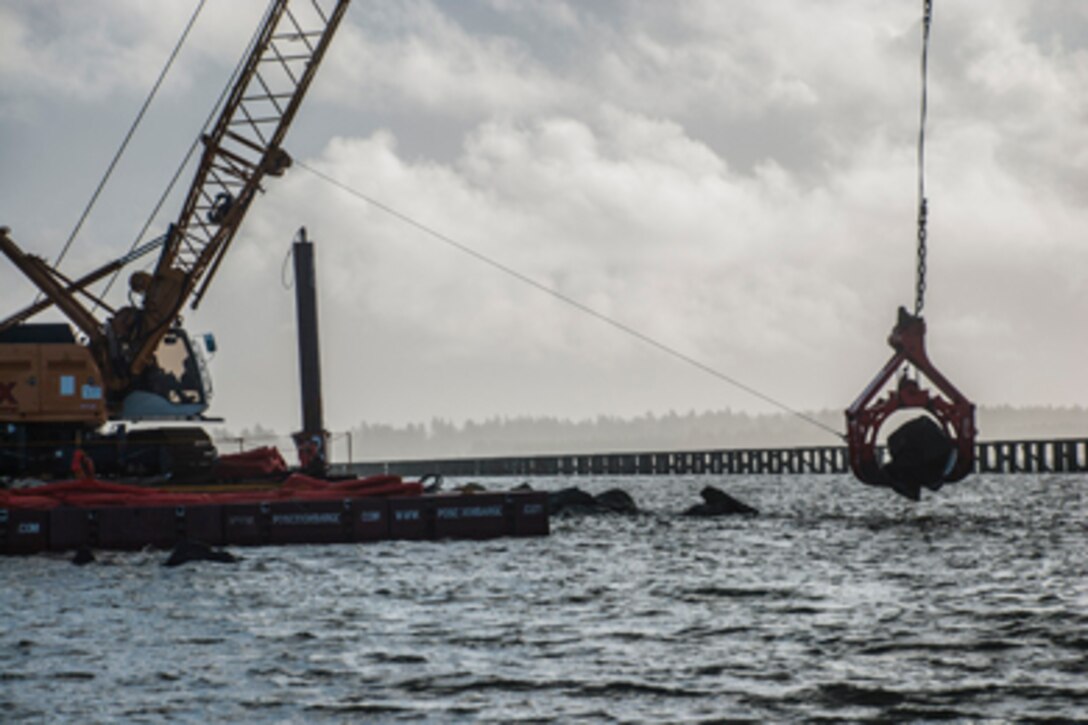 WARRENTON, Oregon — A crane relocates a large jetty stone, Jan. 22, 2016. The U.S. Army Corps of Engineers, the Columbia River Estuary Study Taskforce and other state and local partners are working together to create fish passages in the Trestle Bay jetty. (Photo by Jeffrey Henon. Courtesy U.S. Army Corps of Engineers)