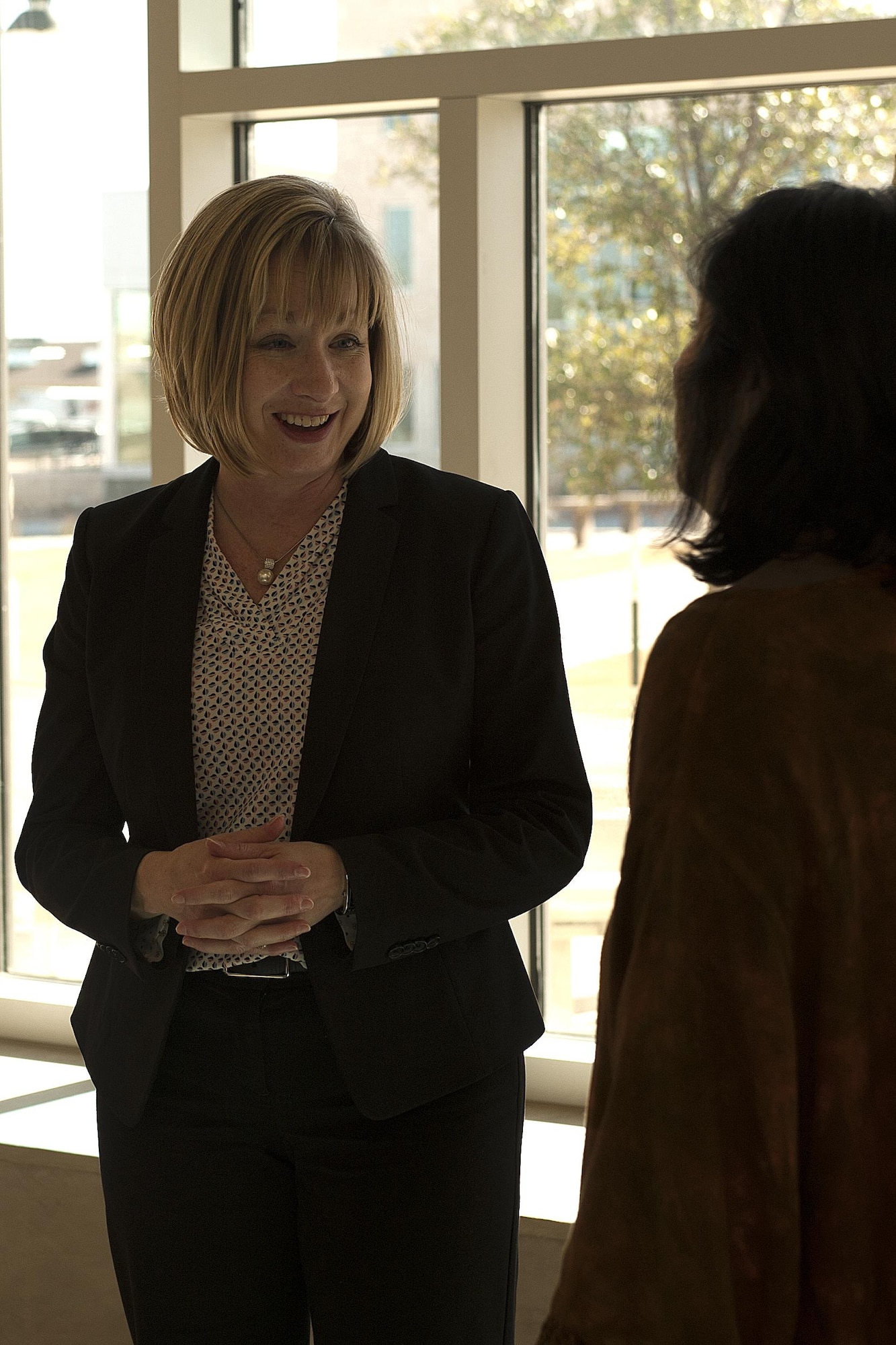 Toni L. Hansen, 17th Force Support Squadron Director, speaks to Pam Callan, Howard College District Teaching and Learning Dean, during the Memorandum of Understanding signing at Howard College, San Angelo, Texas, Feb. 2, 2016. Howard College, Goodfellow Air Force Base 17th Force Support Squadron Airman and Family Services Flight and Concho Valley Workforce Development Board signed the MOU to train child and youth program employees and childcare providers. (U.S. Air Force photo by Airman 1st Class Caelynn Ferguson/Released)

