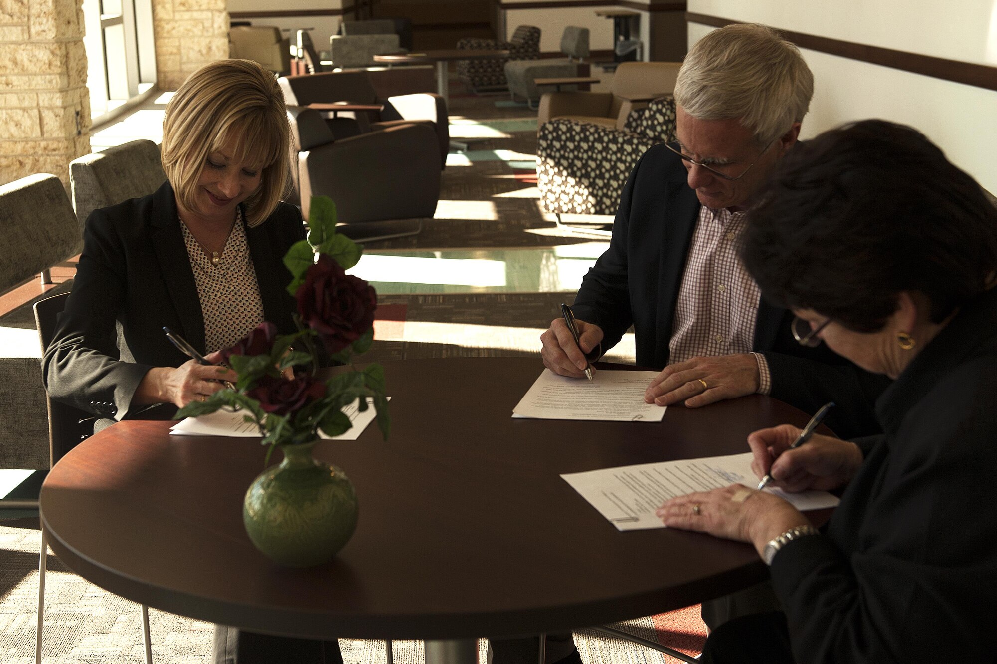 Toni L. Hansen, 17th Force Support Squadron Director, signs a Memorandum of Understanding with Mike Buck, Concho Valley Workforce Development Board executive director, and Jamie Rainey, Howard College executive director, at Howard College, San Angelo, Texas, Feb. 2, 2016. Goodfellow Air Force Base and CVWDB will inform their employees of the academic coaching services and class credits for child and youth program training at Howard College. (U.S. Air Force photo by Airman 1st Class Caelynn Ferguson/Released)

