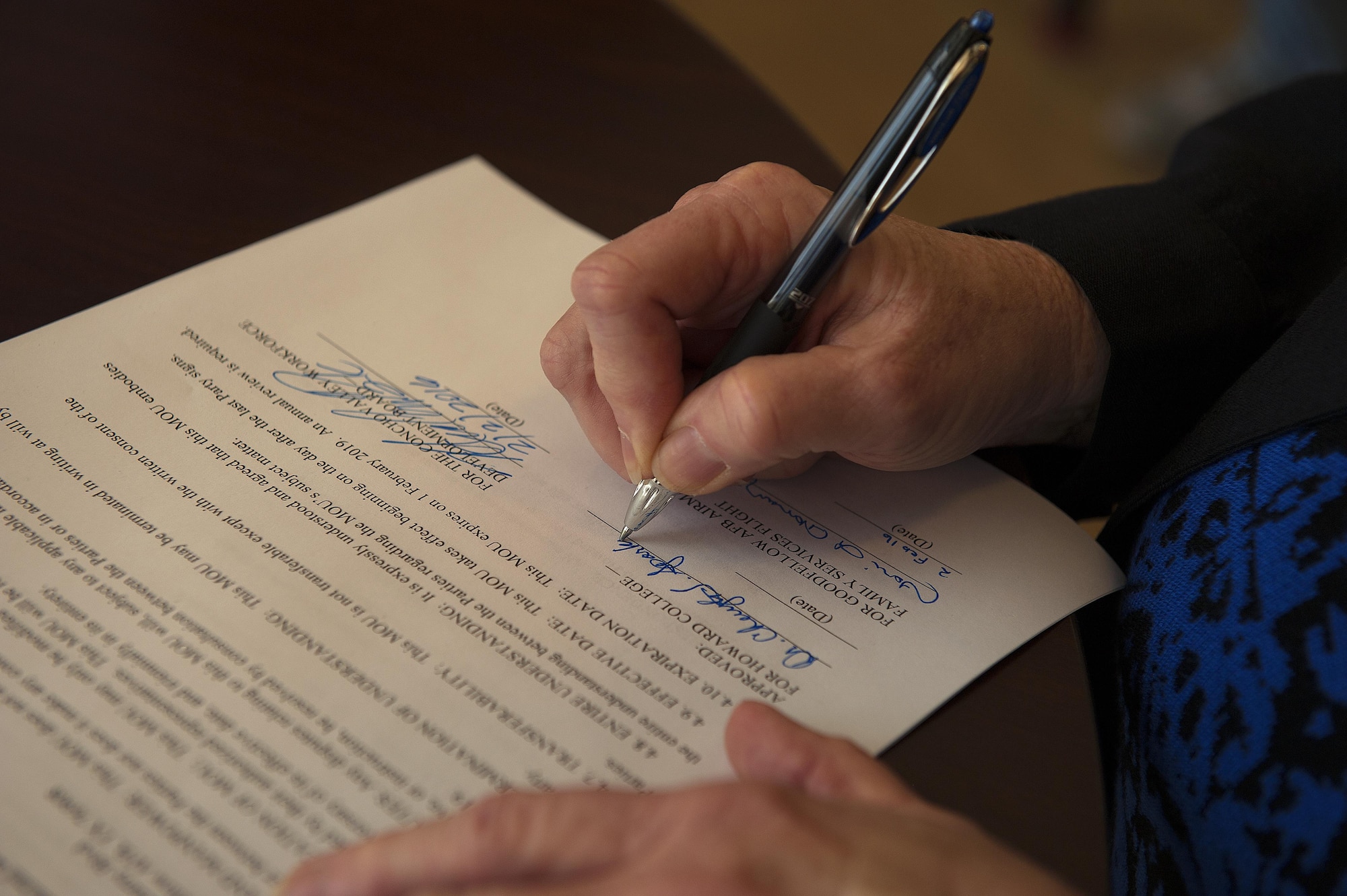 Jamie Rainey, Howard College executive director, signs a Memorandum of Understanding at Howard College, San Angelo, Texas, Feb. 2, 2016. Howard College will offer Continuing Education Units credits for Goodfellow Air Force Base and Concho Valley Workforce Development Board employees and providers who wish to train in child and youth programs. (U.S. Air Force photo by Airman 1st Class Caelynn Ferguson/Released)

