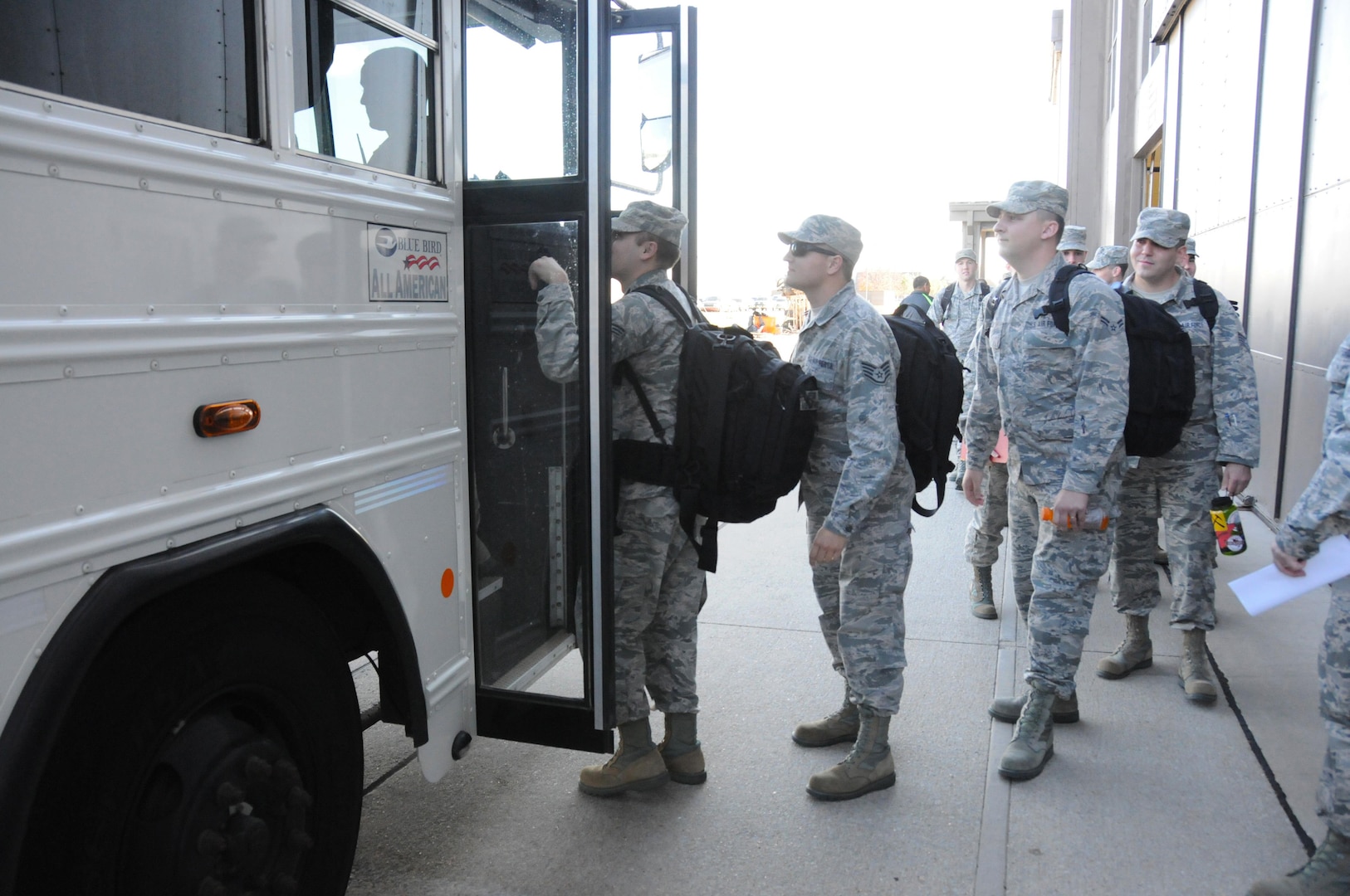 Airmen assigned to the 134th Air Control Squadron climb aboard buses and deploy from McConnell Air Force Base in support of operations Nov. 11, 2015. The squadron's departure was part of a much larger mobilization of the 184th Intelligence Wing that deployed members to locations all over the world, making it one of the largest deployments in the wing's recent history.
