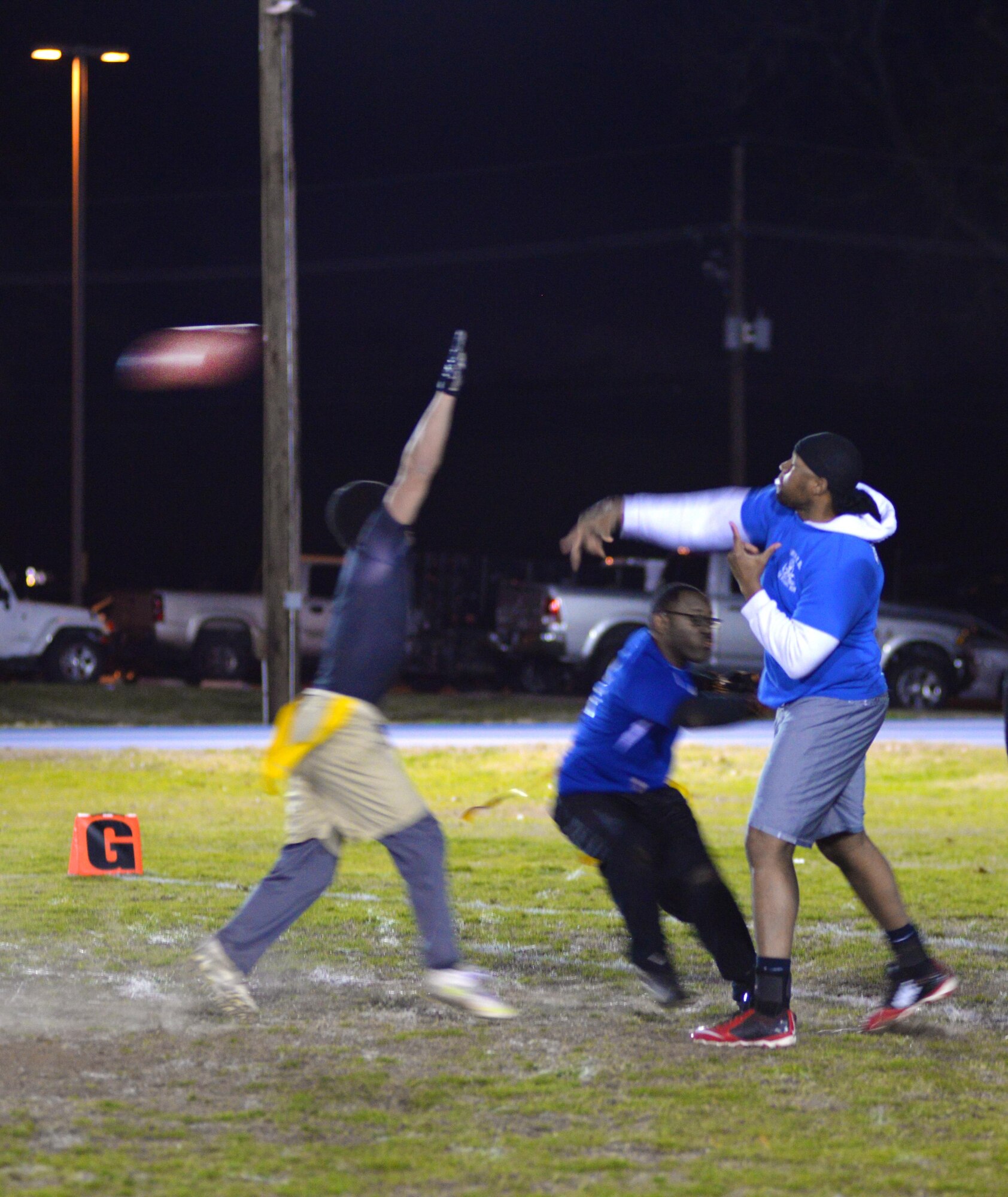 The 2nd Force Support Squadron flag football quarterback throws a pass as the defense closes in during a playoff semifinals game at Barksdale Air Force Base, La., Jan. 27, 2016. The top ranked 2nd FSS team, which entered the playoffs 10-0, fell to the 2nd Maintenance Squadron 6-7. (U.S. Air Force photo/Airman 1st Class Curt Beach)
