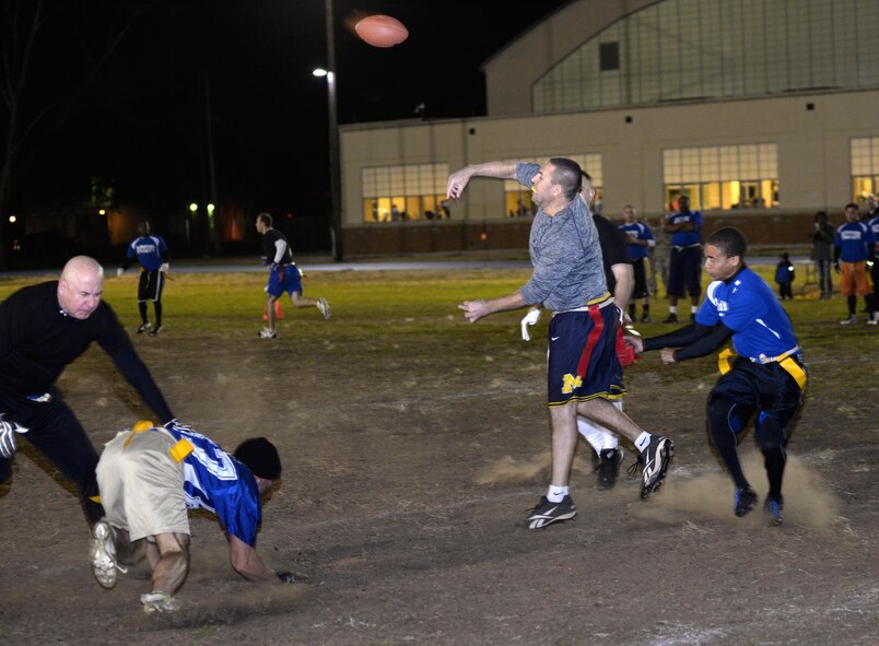 Matt Wireman, Air Force Global Strike Command/8th Air Force quarterback, throws a pass as the defense closes in during the flag football championship game at Barksdale Air Force Base, La., Jan. 28, 2016. Wireman threw for three touchdowns, leading his team to a hard-fought 21-19 victory. (U.S. Air Force photo/Airman 1st Class Curt Beach)