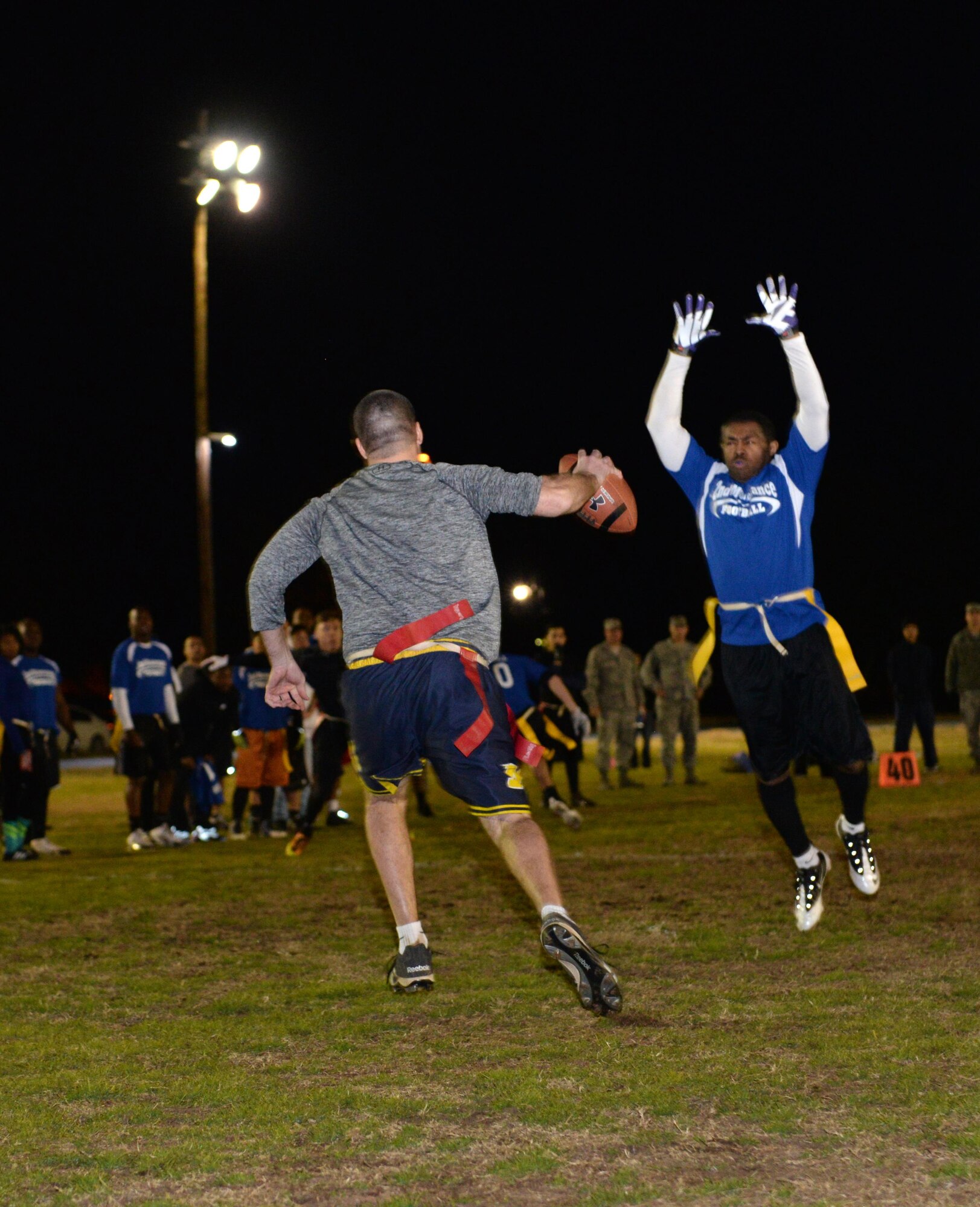 Matt Wireman, Air Force Global Strike Command/8th Air Force quarterback, dodges a defender during the flag football championship game at Barksdale Air Force Base, La., Jan. 28, 2016. The AFGSC/8th AF team defeated the 2nd Maintenance Squadron 21-19. (U.S. Air Force photo/Airman 1st Class Curt Beach)