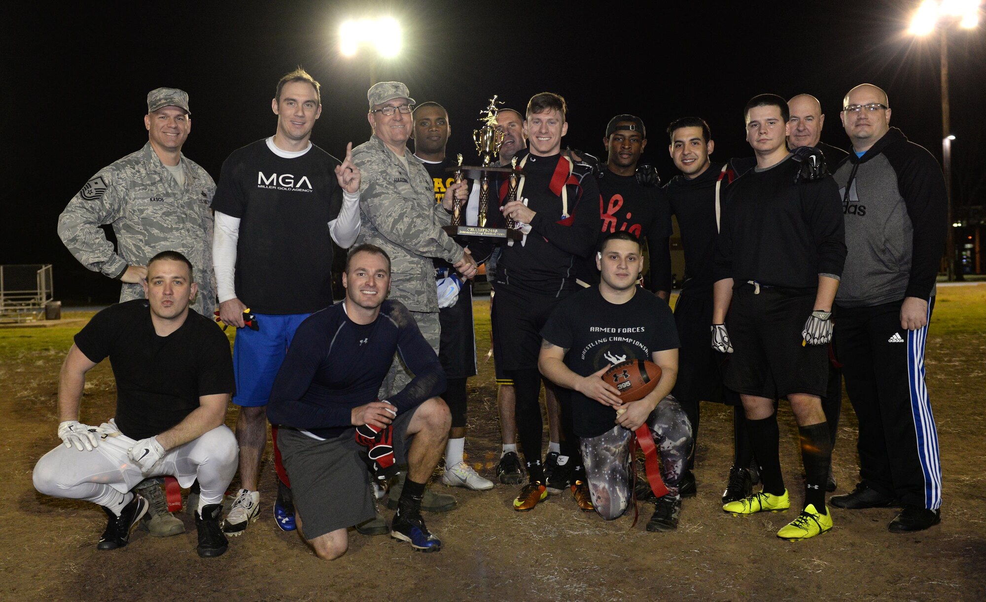 Col. Craig Harding, 2nd Mission Support Group commander, presents the Air Force Global Strike Command/8th Air Force flag football team with the championship trophy at Barksdale Air Force Base, La., Jan. 28, 2016. The AFGSC/8th AF team defeated the 2nd Maintenance Squadron 21-19 in the championship game. (U.S. Air Force photo/Airman 1st Class Curt Beach)