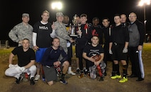 Col. Craig Harding, 2nd Mission Support Group commander, presents the Air Force Global Strike Command/8th Air Force flag football team with the championship trophy at Barksdale Air Force Base, La., Jan. 28, 2016. The AFGSC/8th AF team defeated the 2nd Maintenance Squadron 21-19 in the championship game. (U.S. Air Force photo/Airman 1st Class Curt Beach)