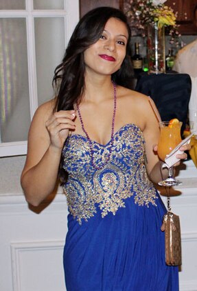 MARINE CORPS BASE QUANTICO, Va. — Sgt. Stephanye Medina, Manpower Management Records and Performance, poses with a drink at the Headquarters and Service Battalion Masquerade Ball on Jan. 29.